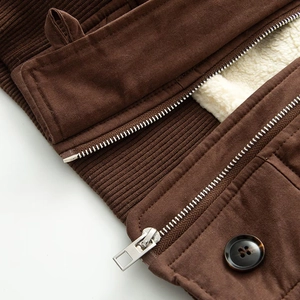 Detail of short denim jacket showing sherpa lining and brown faux suede texture