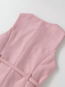 Detail of pink tweed sleeveless top showing premium woven texture and back waist belt