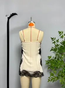 Detail of cream satin camisole with black eyelash lace trim and thin shoulder straps