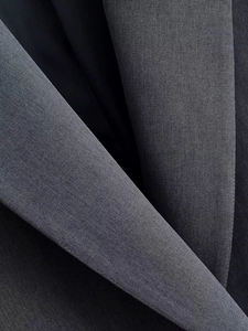 Macro view of dark grey suit lapel texture and inner lining on tailored formal blazer