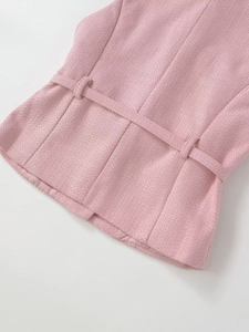 Detail of pink tweed fabric texture with waist belt and clean stitching for women