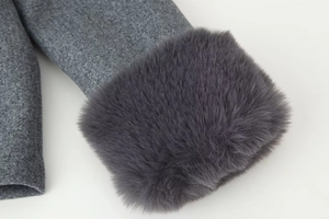 Detailed view of grey wool coat cuff featuring luxurious dark grey faux fur trim