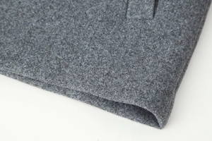 Detailed macro view of high-quality grey wool blend fabric texture for short coats