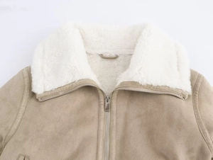 Detail of faux suede jacket with plush sherpa collar and metallic front zipper closure