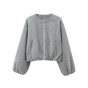 Detail of soft grey fleece baseball jacket featuring ribbed cuffs and silver front zipper