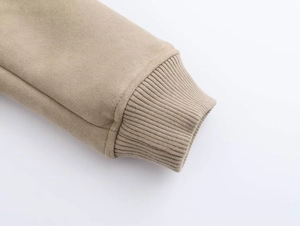 Detail of khaki faux suede jacket cuff with ribbed knit elastic wristband design