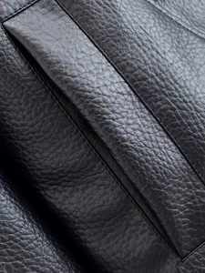 Macro shot of high-quality black litchi texture faux leather and neat stitching detail