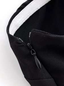 Detailed macro view of invisible zipper and anti-slip tape on black tube dress