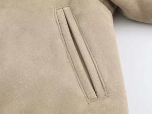 Close-up detail of pocket stitching on khaki faux suede zip jacket for women