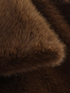 Close-up of premium dark brown faux fur texture with silky gloss for winter coat