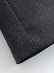 Macro shot of high-quality dark grey twill suit fabric with precise stitching details