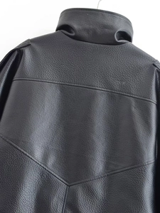 Detail of vintage black grain leather jacket featuring stand collar and back V-shaped stitching