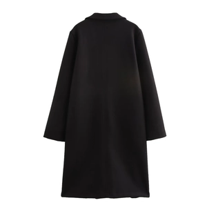 Detail view of the back of a minimalist mid-length black coat with tailored straight cut