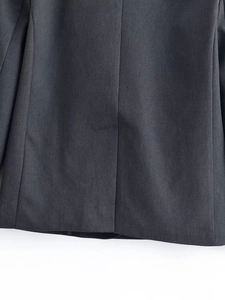 Detailed close-up showing the vertical back seam and premium grey fabric of the suit jacket