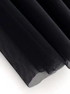 Close-up of high-density black layered tulle fabric with delicate mesh texture and pleats