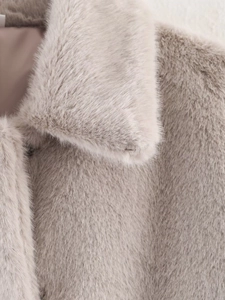 Detailed macro shot of premium beige faux fur collar and silky inner lining