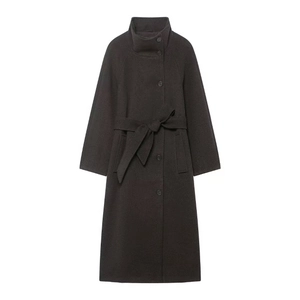 Close-up of soft wool blend texture on minimalist high collar coat with waist belt
