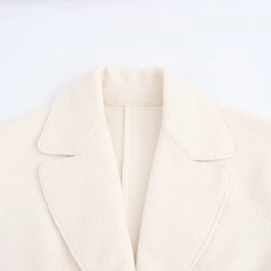 Minimalist beige wool blend coat with elegant notched lapel and tonal topstitching