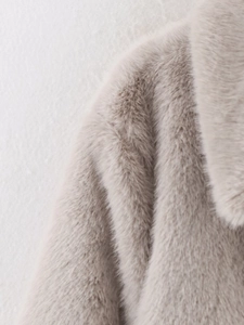Detail of high-density faux fur shoulder and collar on a plush beige winter coat