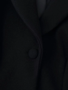 Detail of wool blend coat collar featuring high-quality matching fabric buttons