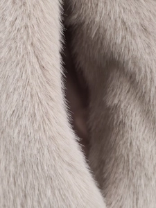 Close-up of premium light beige faux fur texture with soft silky fibers for winter coats