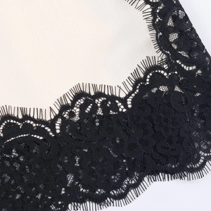 Elegance satin top with black eyelash lace trim detail and floral embroidery pattern