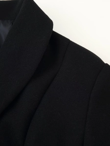 Close-up of lapel and stitching on high-quality black wool blend long overcoat