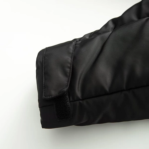 Detail of adjustable velcro cuff on black functional hooded jacket with premium stitching