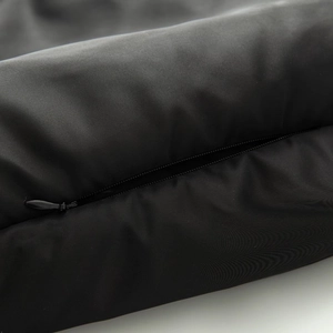 Close-up of black techwear hooded jacket featuring an invisible zipper and grid texture