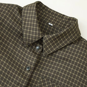 Women's padded shoulder plaid shirt jacket in dark brown and olive green check