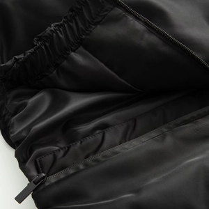 Detailed close-up of premium black nylon lining with elastic pleats and sleek zipper detail