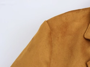 Close-up of caramel faux suede blazer showing high-quality shoulder stitching and fabric texture