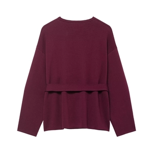 Detail view of the back of a burgundy knit coat with drop shoulders and matching waist belt