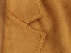 Detailed macro shot of camel faux suede blazer featuring precision double-needle stitching