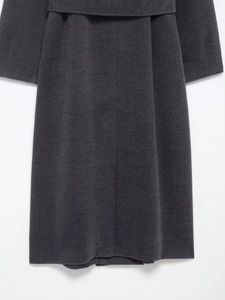 Detail of dark grey wool coat featuring back waist panel and premium textured fabric