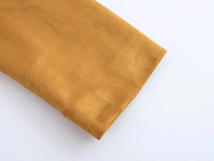 Detailed close-up of ginger yellow faux suede fabric with soft texture and refined finish