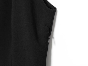 Detail of hidden zipper construction and high-quality black fabric texture on blazer dress