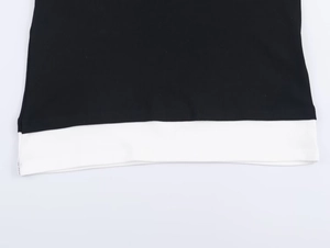 Détail de l'ourlet contrasté noir et blanc avec texture côtelée et coutures de précision