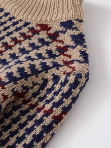 Dettaglio della maglia pied-de-poule di un maglione a maniche lunghe tricolore
