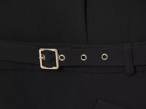 Detailed macro view of black blazer dress waist belt with a golden square buckle fastener