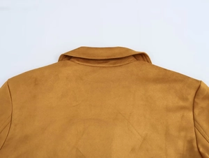 Detail view of tan faux suede texture on the collar and back of a stylish women blazer
