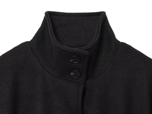 Detailed close-up of high stand collar and double button closure on black wool coat
