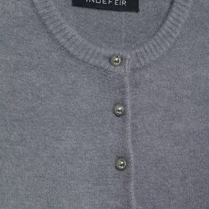 Minimalist grey knit cardigan featuring textured wool blend and silver spherical buttons