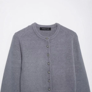 Women's minimalist grey knit cardigan featuring elegant silver spherical metal buttons