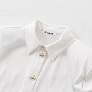 Chic white long-sleeve crepe shirt with padded shoulders and gold textured buttons