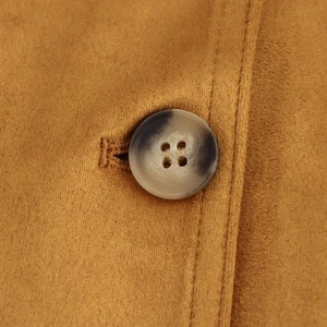 Close-up of faux suede blazer jacket featuring a marble-patterned button and fine stitching