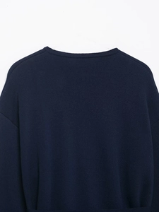 Detail of the knit texture and neckline on this navy blue wool blend short coat