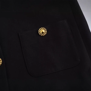 Elegant black jacket featuring textured twill fabric and vintage gold chain-link buttons
