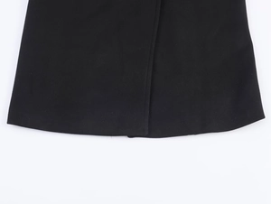 Detailed close-up showing high-quality stitching on black wool blend coat hemline