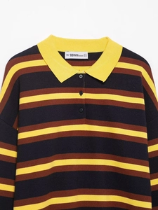 Detail of striped polo knit sweater showing yellow collar and branded size label